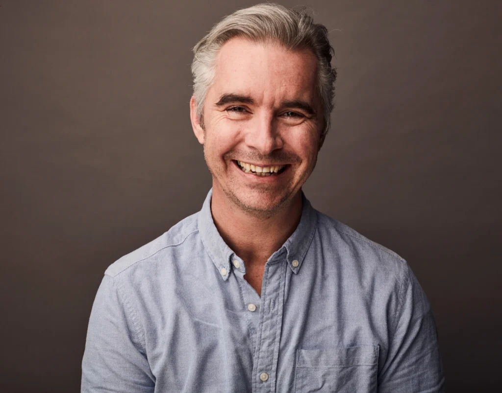 Portrait photo of Ben Lily in brown background