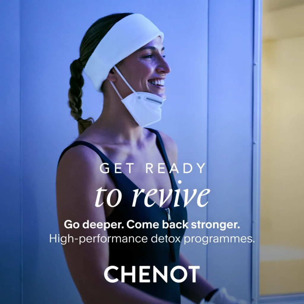 A woman wearing a white headband, face mask, and gloves stands in a spa or wellbeing centre. Text on the image promotes Chenot detox programmes.